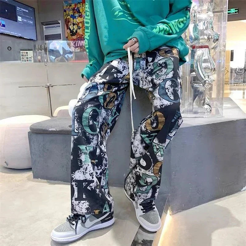 Black and teal high street graffiti trousers man american with loose wide-leg fit and distressed graphic print