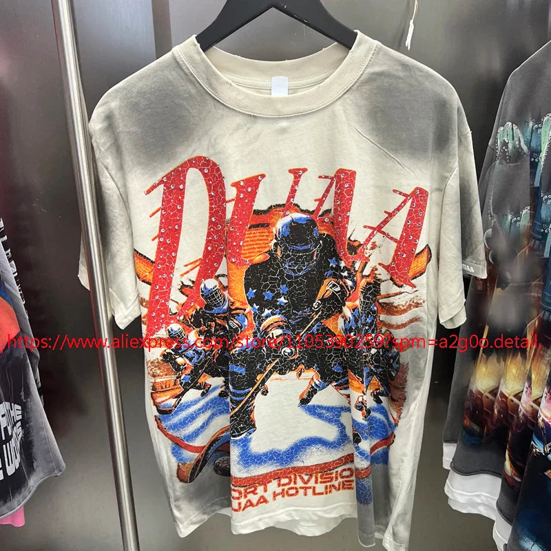 A faded off-white vintage style oversized t-shirt with cracked soldiers graphic and red blue accents from High Street Hip Hop
