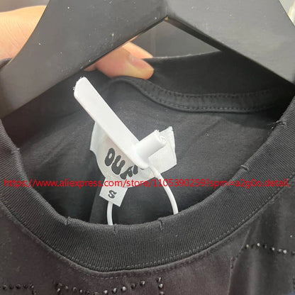Black cotton high street hip hop oversize t-shirt with white tag and black studs along the neckline