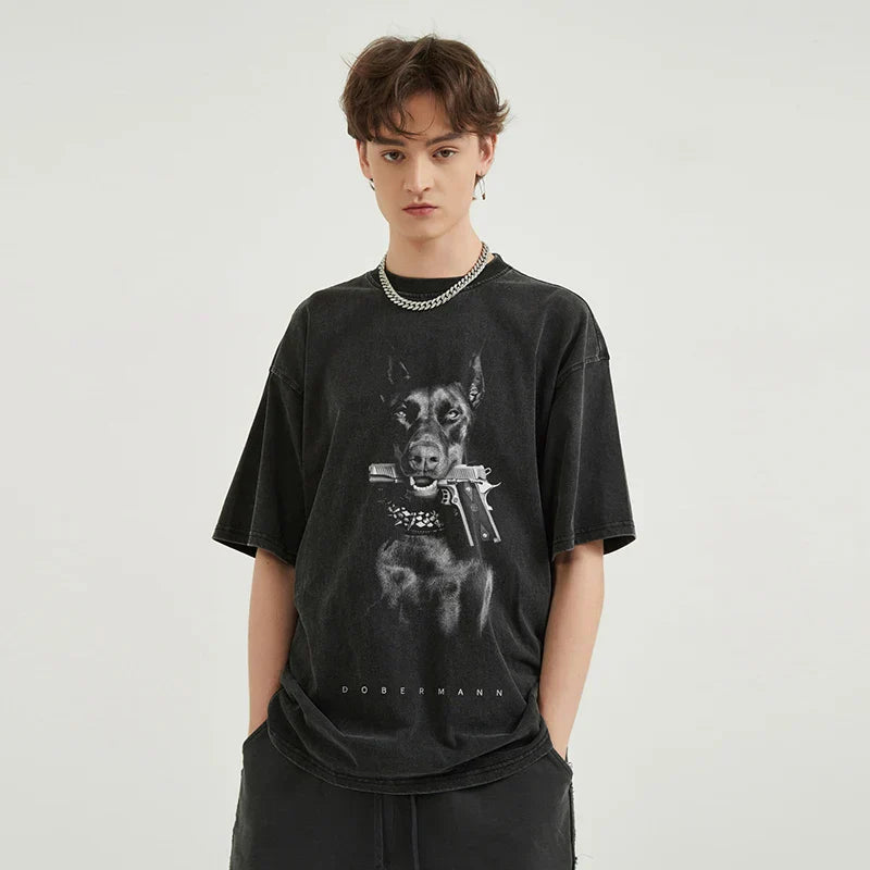 Black vintage washed cotton oversized t-shirt featuring a streetwear doberman dog gun graphic and dobermann text for hipster tops tee