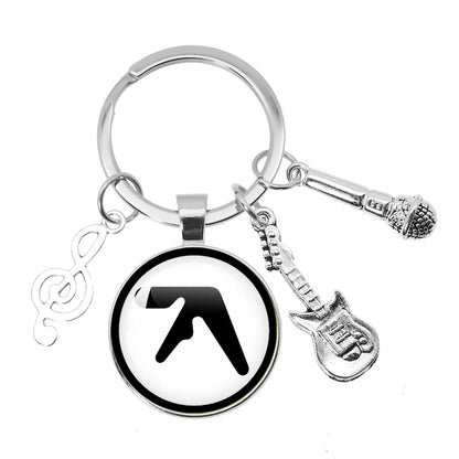 Silver keychain with aphex twin logo circular glass pendant and music themed charms for backpack accessories souvenir