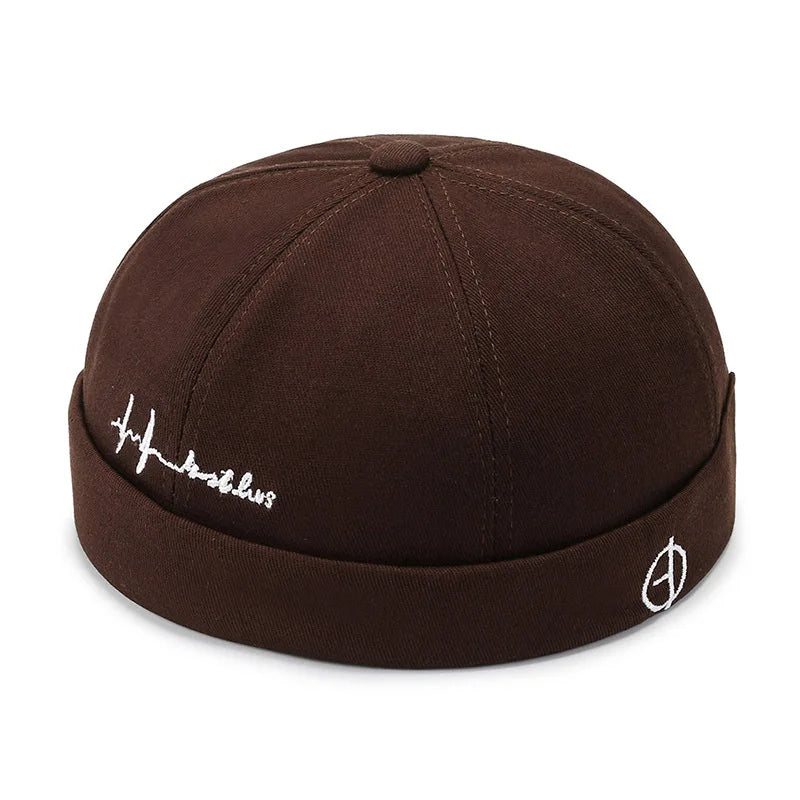 Brown fabric hip hop blue landlord hat docker with white embroidered script and rolled edge brimless design