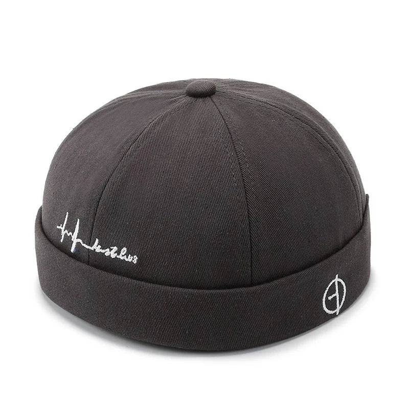 Dark gray textured fabric washed cotton landlord cap with folded brim and white embroidered logo for hip hop blue edge brimless sailor look