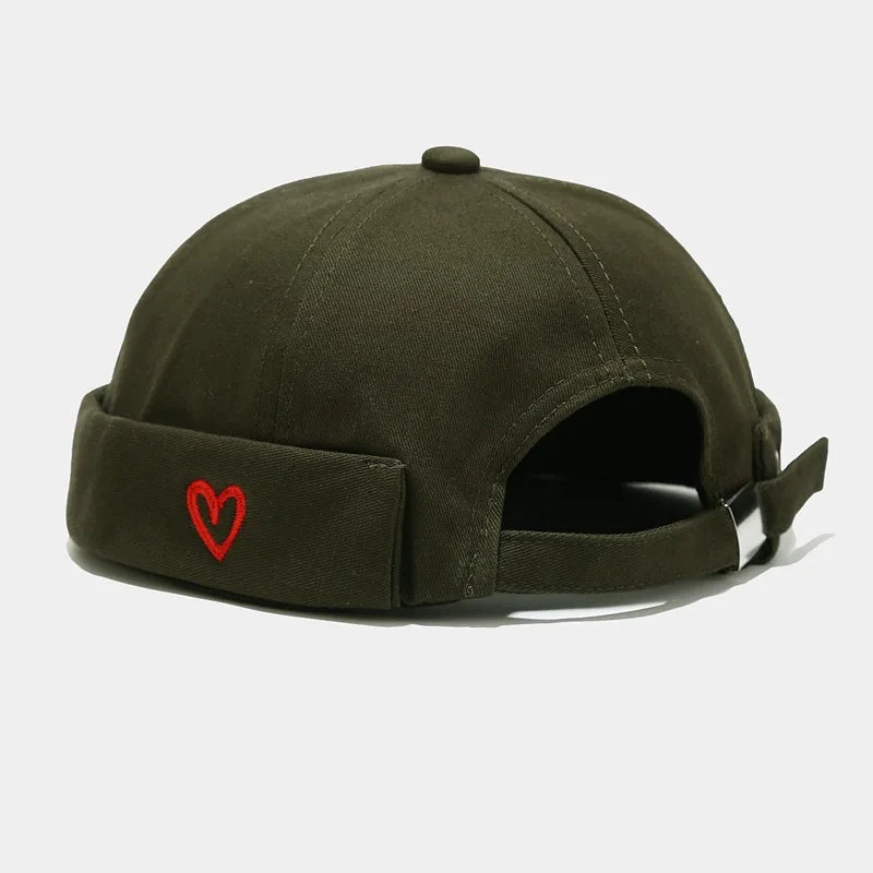 Olive green cotton landlord hat docker with red embroidered heart on folded brim and rolled edge brimless design
