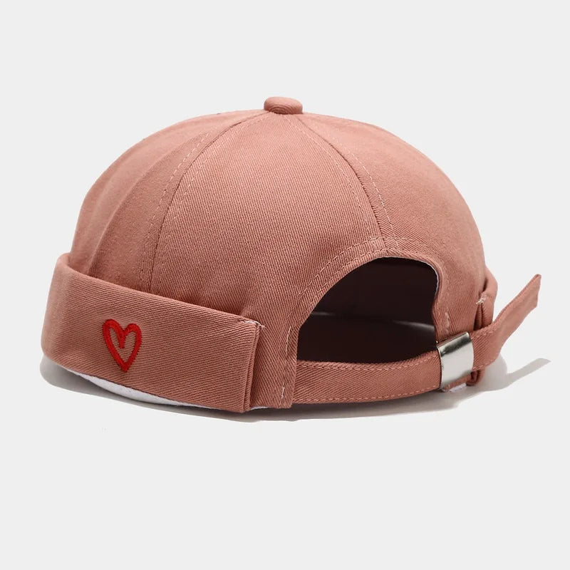 A soft rose-colored washed cotton landlord cap with a red heart embroidery and silver buckle strap for hip hop blue edge brimless sailor style
