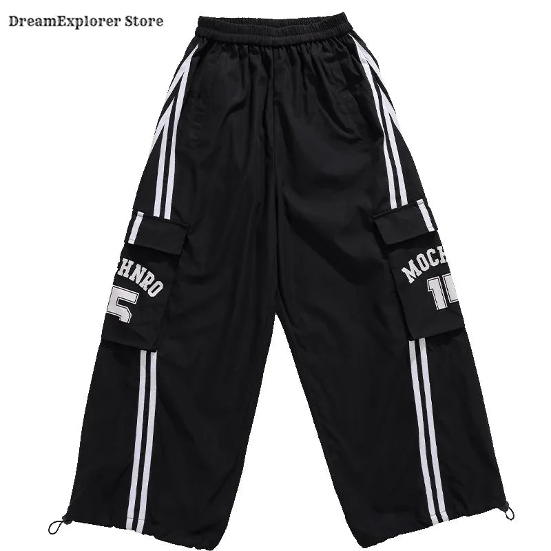 Black cargo pants with white vertical stripes and lettering on pockets for hip hop boys kids jazz costumes streetwear