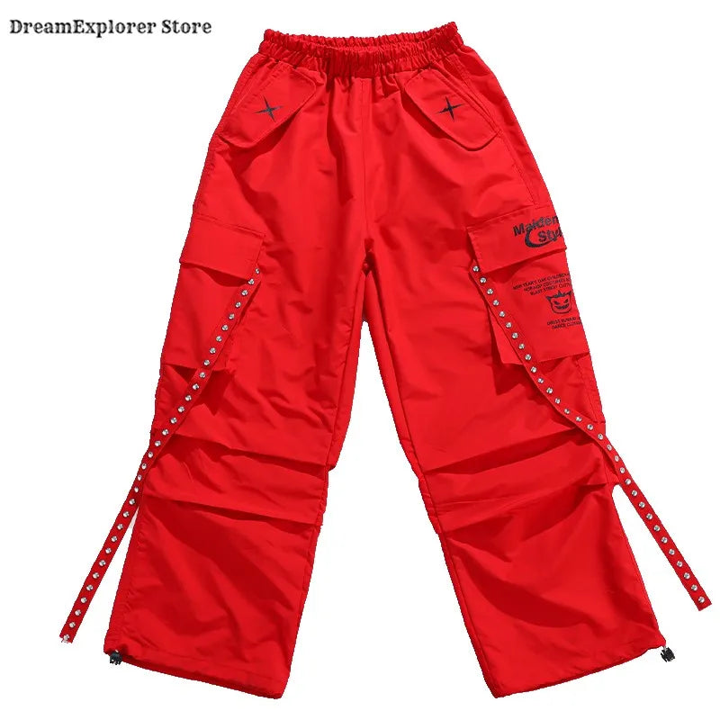 Bright red hip hop boys cargo pants with studded side straps and a branded patch for kids jazz costumes