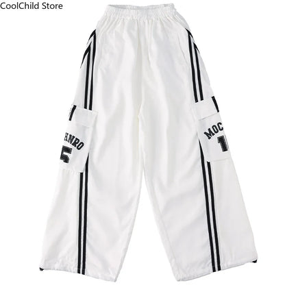 White hip hop boys cargo pants with black vertical stripes and lettering on pockets for cool graffiti dance wear