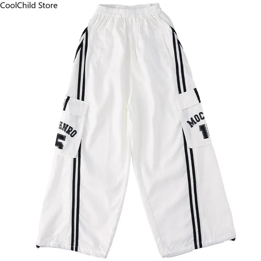 White hip hop boys cargo pants with black vertical stripes and lettering on pockets for cool graffiti dance wear