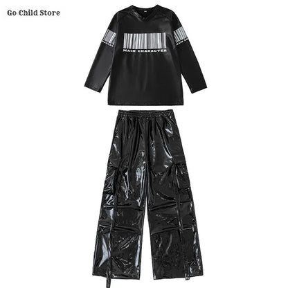 Black glossy vinyl hip hop long-sleeve top with white barcode and main character text paired with shiny cargo pants