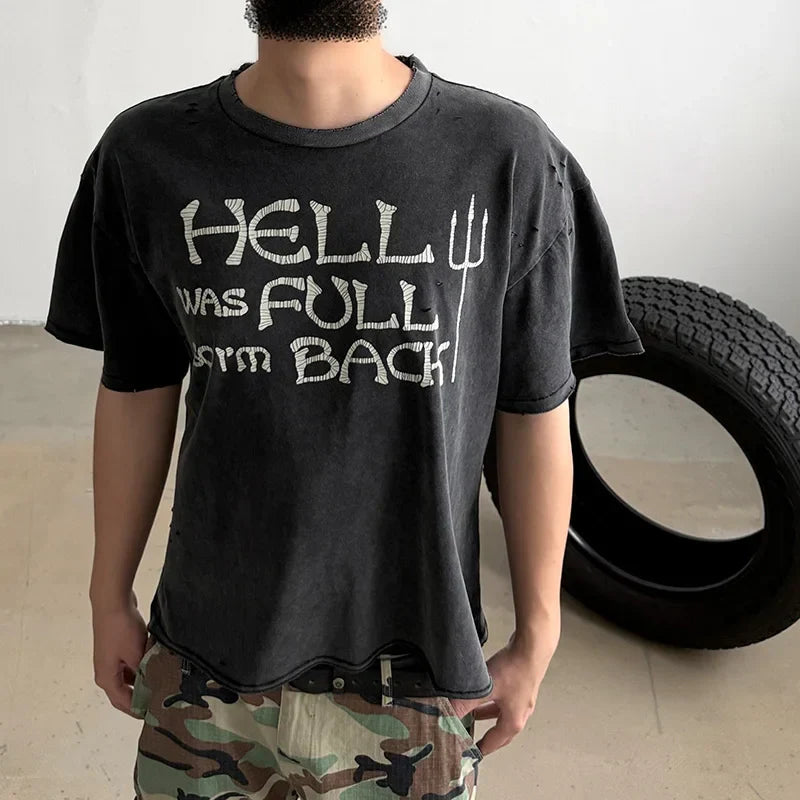 Black distressed oversized damaged hole t-shirt featuring hip hop classic logo print vintage hell was full so im back graphic and trident symbol