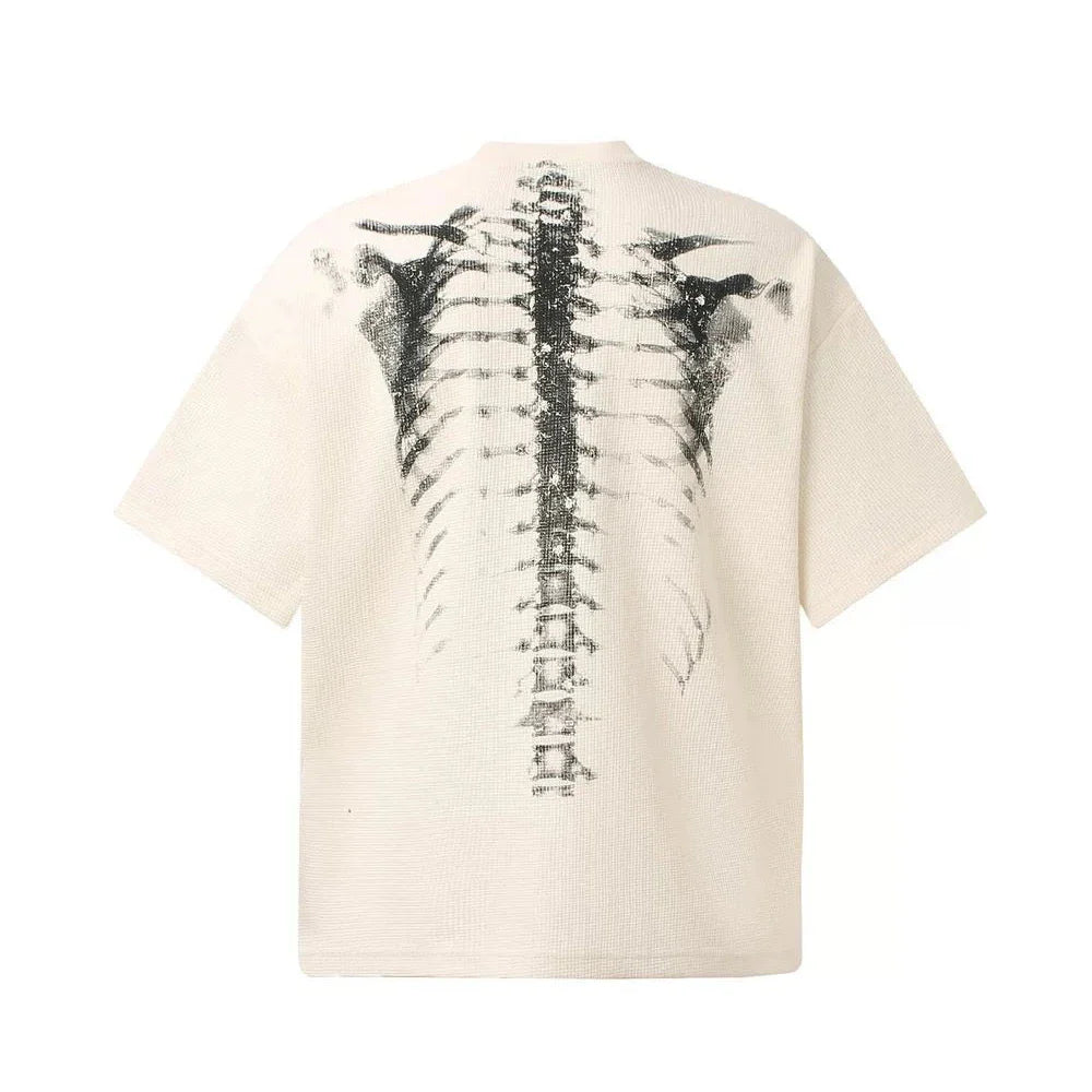 Back view of cream-colored ribbed cotton t-shirt with bold black skeletal spine print in hip-hop streetwear style