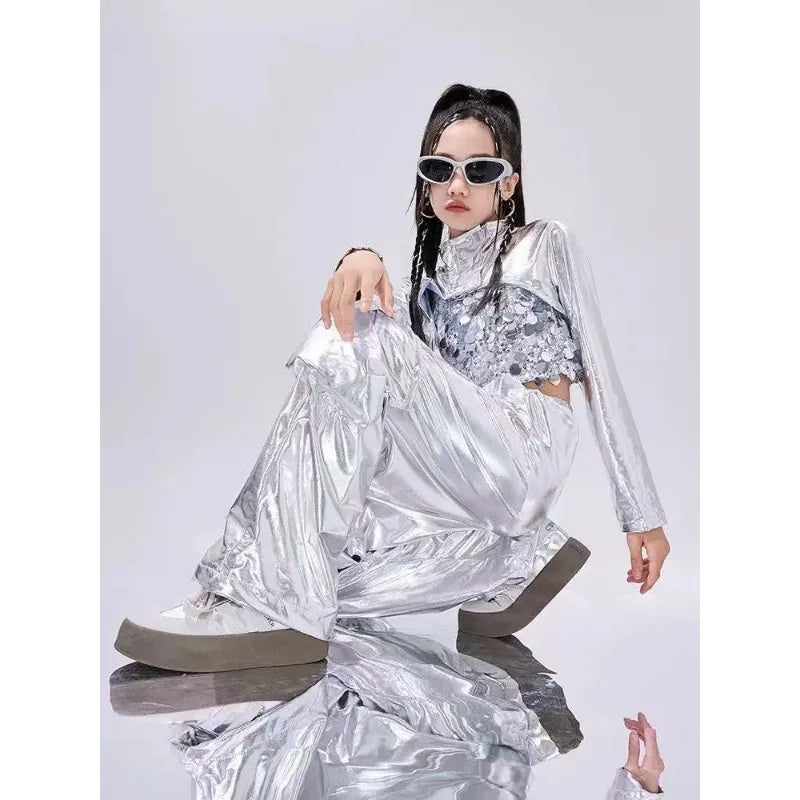 Shiny silver metallic two-piece reflective rave outfit with sequined crop top and matching wide-leg cargo pants for jazz dancewear festival