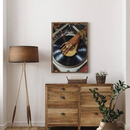 A framed art poster bar featuring a black dj hand with gold jewelry on a vinyl record for hip hop fashion decor
