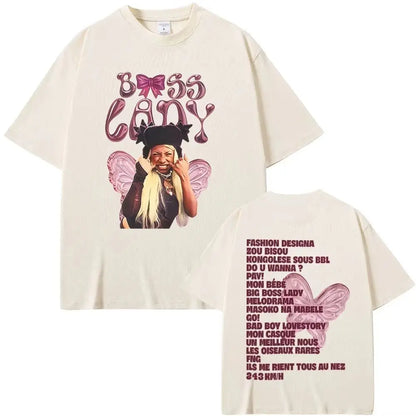Cream-colored oversized hip hop fashion t shirt with boss baby graphic and french lyrics on back by rapper theodora mega