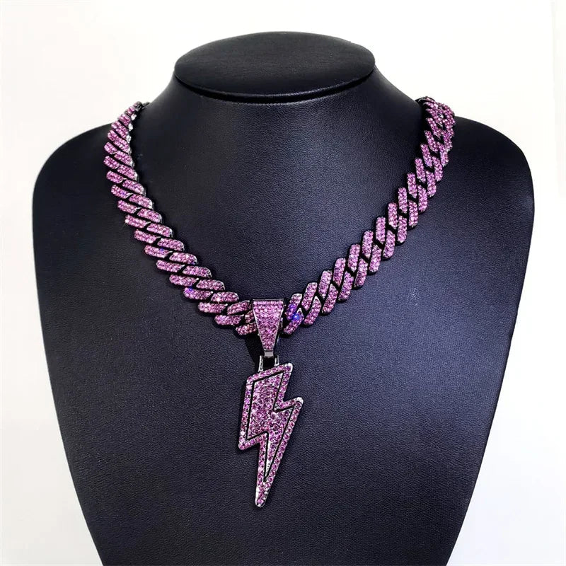 A sparkling pink lightning pendant with purple cz zircon hangs from a silver-tone iced out miami cuban chain