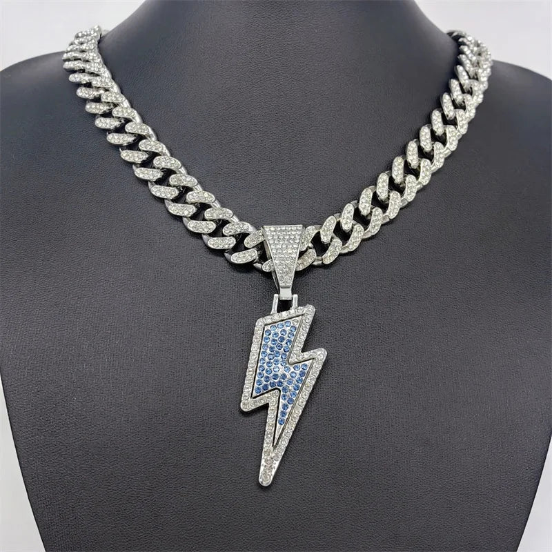 A sparkling silver lightning bolt pendant necklace with purple cz zircon on a 20inch iced out miami cuban chain