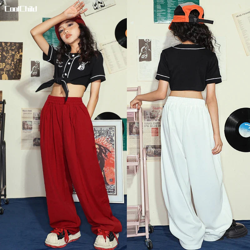 Black cropped top with white trim and embroidered logo paired with wide-leg red or white pants for kids street dance sets