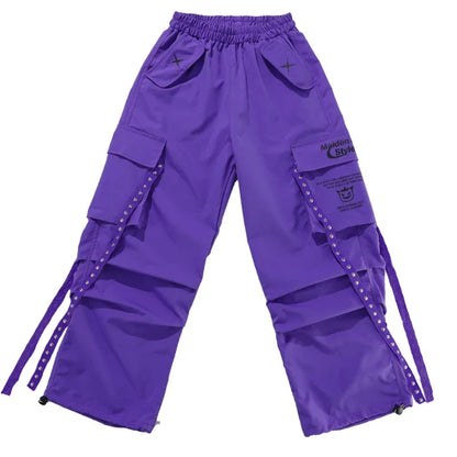 Purple cargo pants with multiple pockets and studded straps featuring a branded patch for kids streetwear group and children street dance