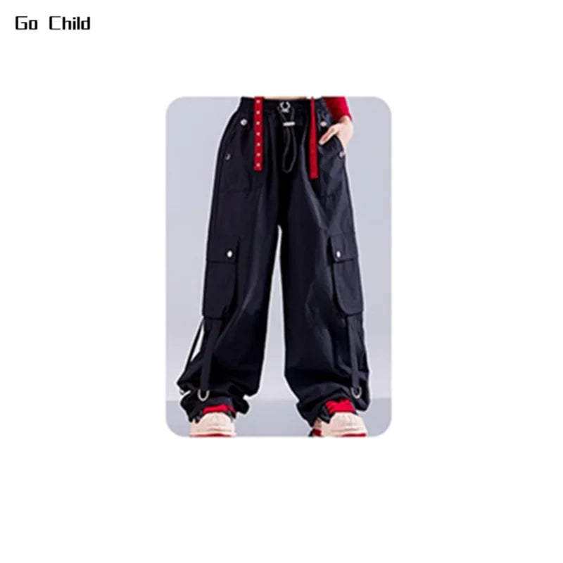 Black cargo pants with red belt accents silver hardware multiple pockets and relaxed fit for hip hop girls street dance cargo and jazz girl group styles