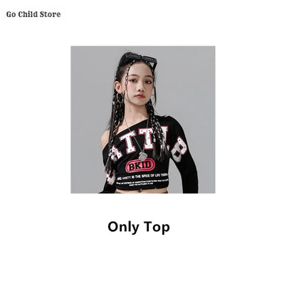 Black long-sleeved one-shoulder crop top with white red lettering and pink bkid logo for girl group streetwear and street dance clothes