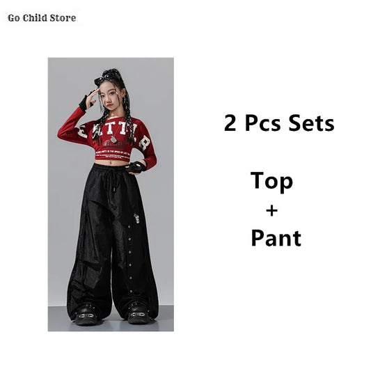 Red long-sleeved crop top with bold white lettering and cropped hemline for girl group streetwear and street dance clothes