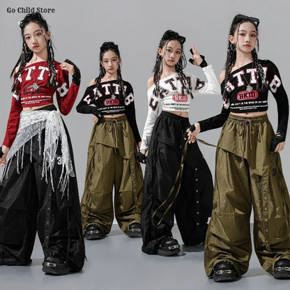 Four young women model hip hop girl group streetwear with bold fatty crop tops and cargo pants kids street dance clothes set