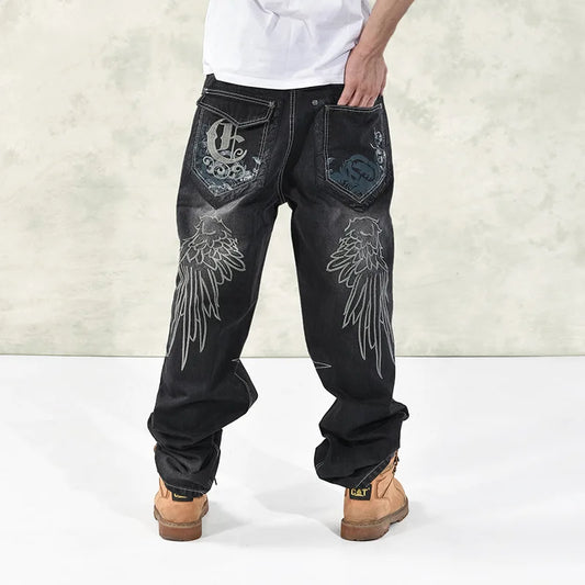 Black denim fat guy skateboard pants streetwear with silver wing embroidery and ornate embroidered back patches