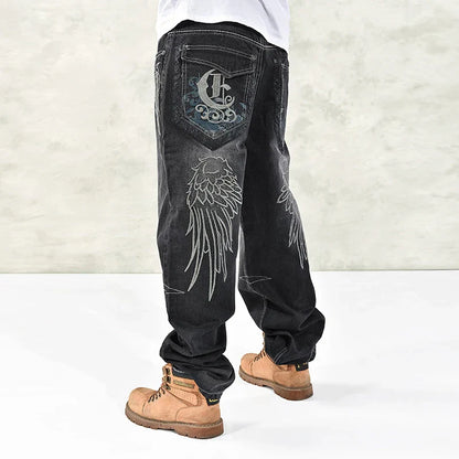 Black denim hip hop graphics embroidered jeans for men with silver wing embroidery and stylized c logo on back pocket