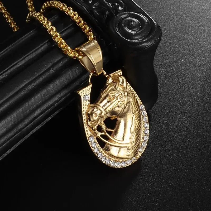 Gold horse head pendant with horseshoe design and clear rhinestones on a shiny cubic zirconia money bag necklace