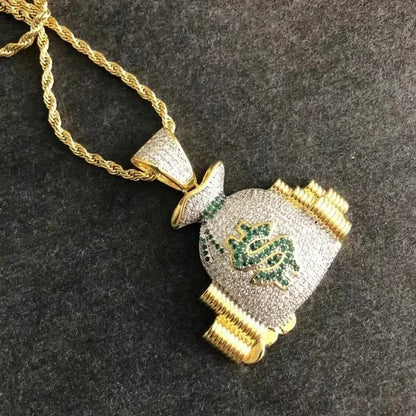 Gold chain money bag necklace with shiny cubic zirconia and green gemstones forming a dollar money bag pendant