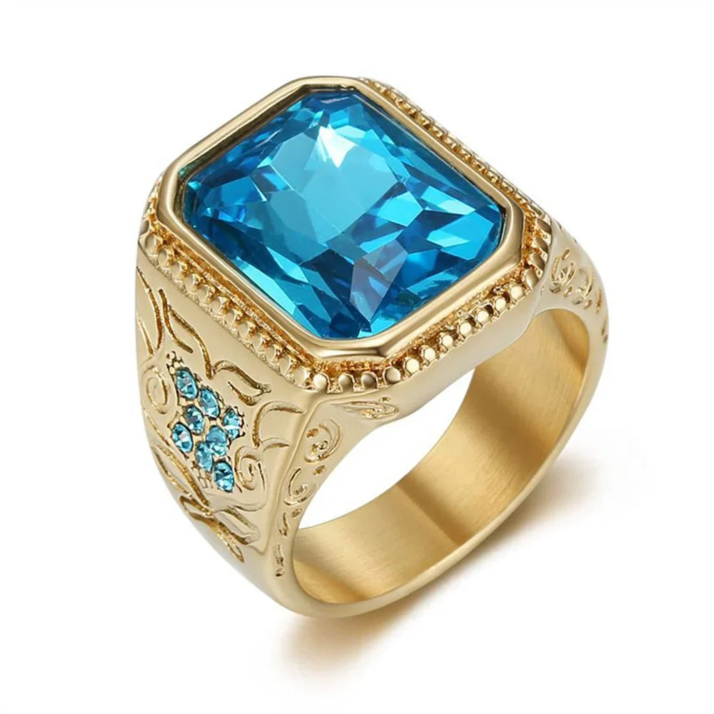 Gold-toned hip hop signet ring with large blue cubic zirconia and geometric floral engraving in stainless steel