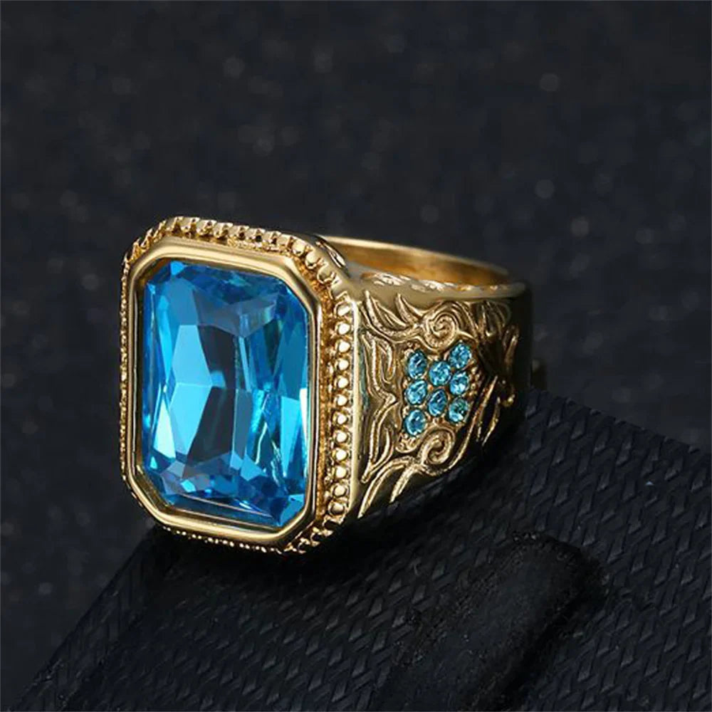 Gold-toned hip hop ring with geometric design featuring blue cubic zirconia on stainless steel band for men