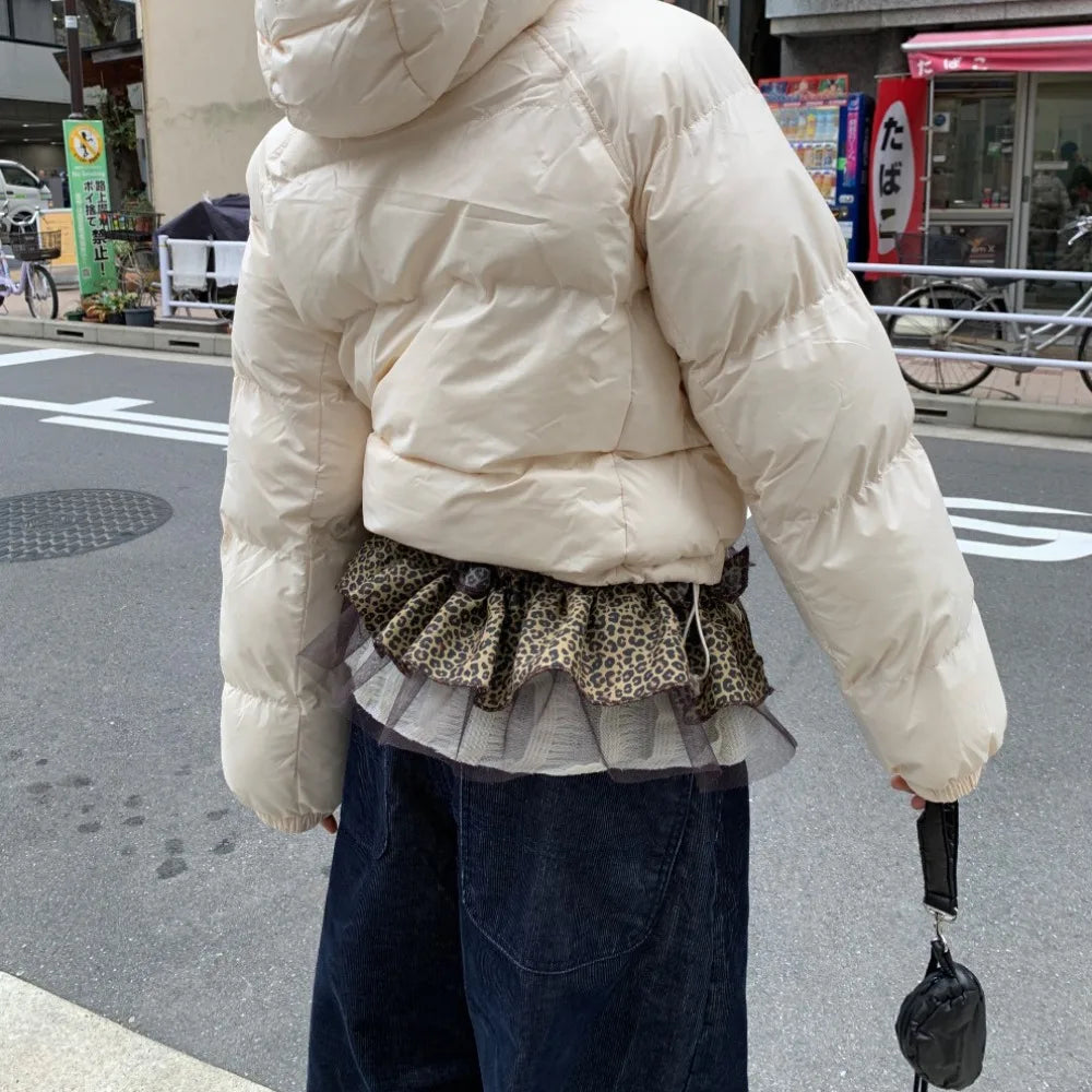 Cream-colored puffer jacket with quilted design and hood paired with leopard print hip scarf skirt with sweet mesh ruffled edge waistband y2k style