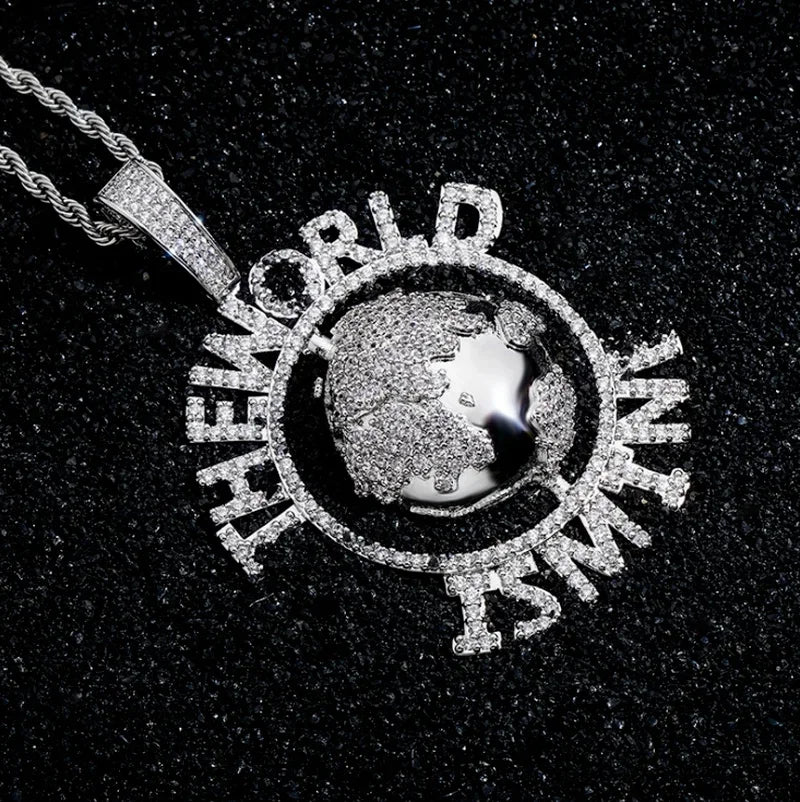 Silver diamond-encrusted world globe pendant with the world is mine lettering on a twisted tennis chain fashion necklace