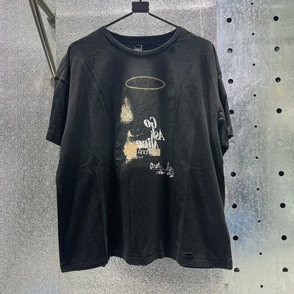 Black distressed cotton graphic tee with hip hop letters, faded gold halo, white text, damaged hole paly design, rhinestone box graphics