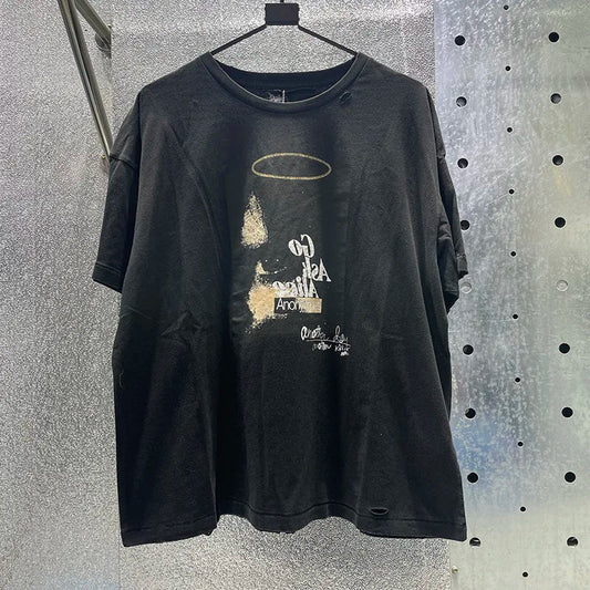 Black distressed cotton graphic tee with hip hop letters, faded gold halo, white text, damaged hole paly design, rhinestone box graphics