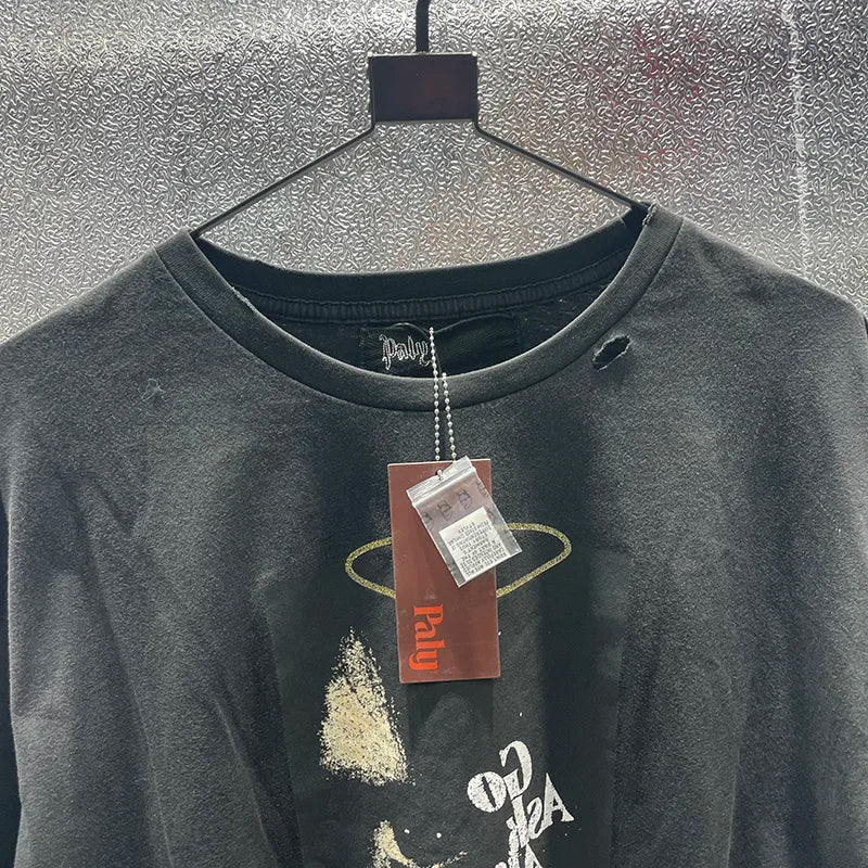 Black distressed cotton hip hop letters graphic tee with faded gold ring box graphics rhinestone design hanging on hanger