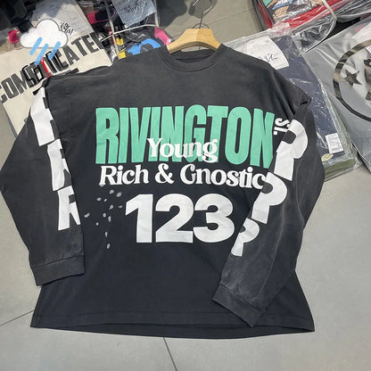 Black long-sleeved cotton t-shirt with bold green and white hip hop letters graphic print across the chest
