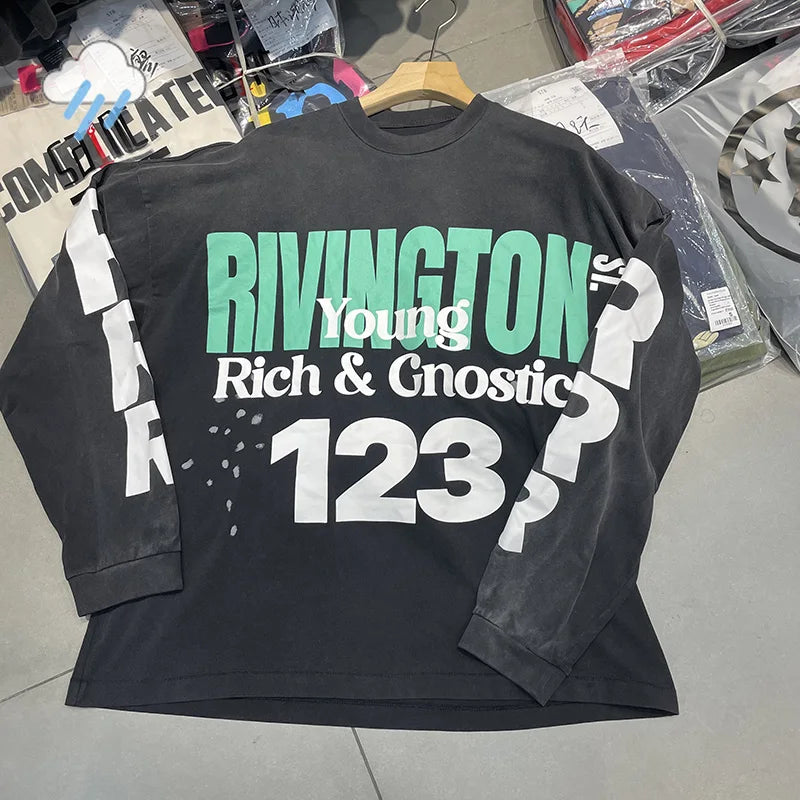 Black long-sleeved oversized cotton tee with bold green and white hip hop letters rrr123 graphic print