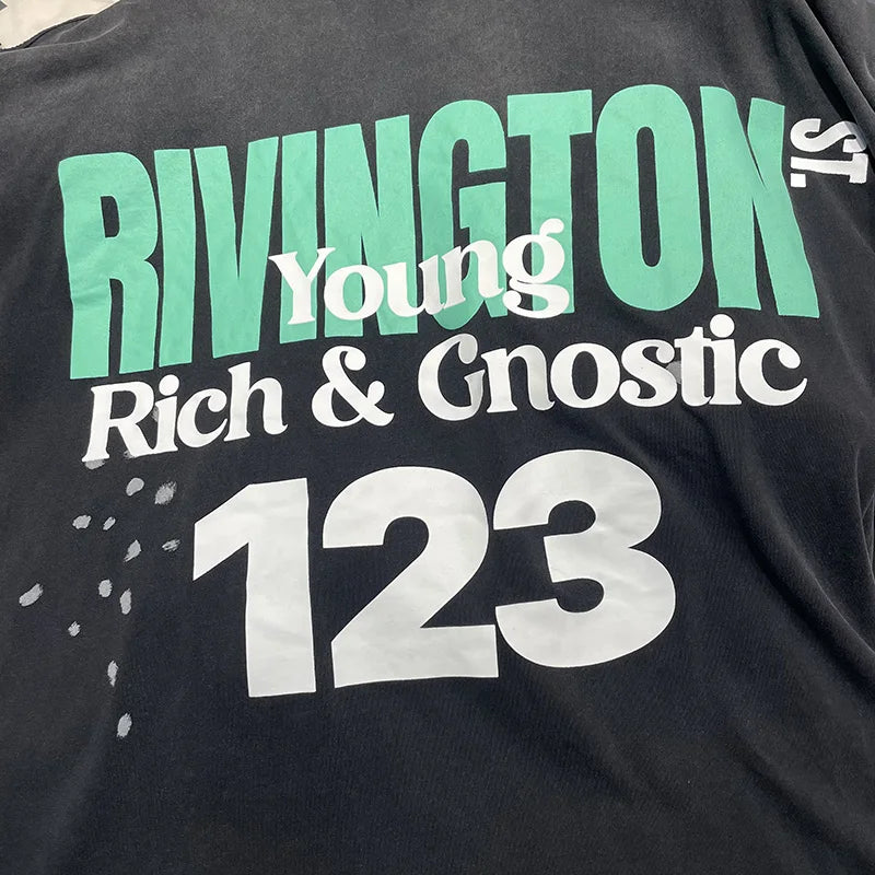 Black cotton oversized long sleeve t-shirt with bold green and white rivington young rich and gnostic 123 graphic print