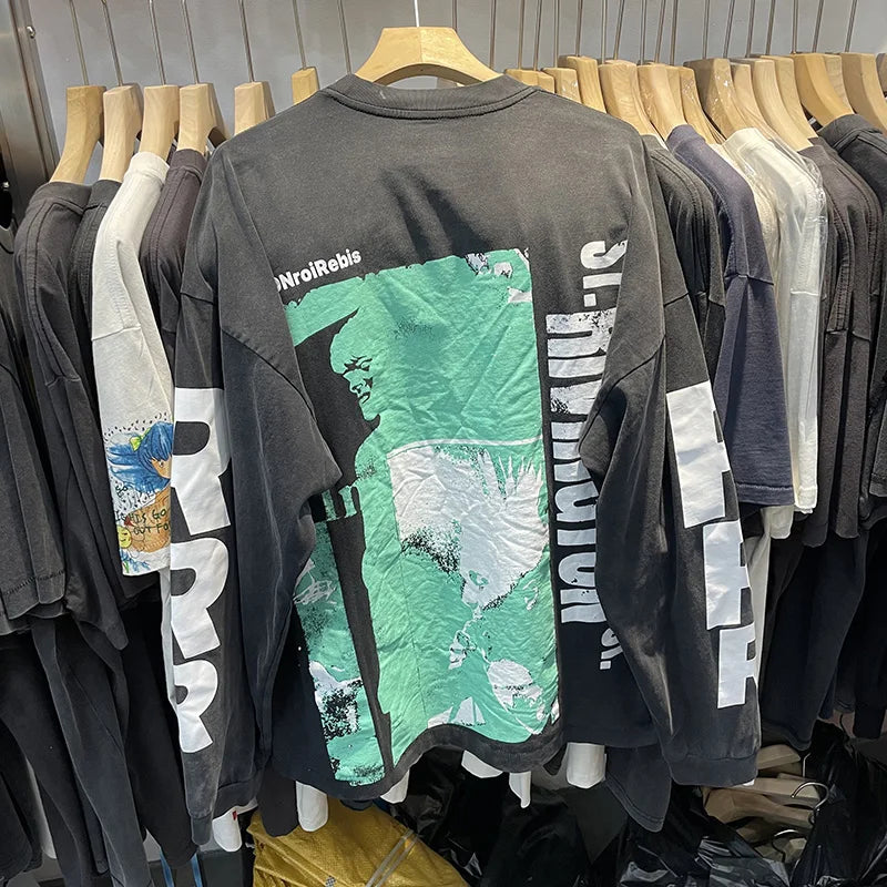 Back view of black oversized long sleeve t shirt with green and white hip hop letters logo print in cotton