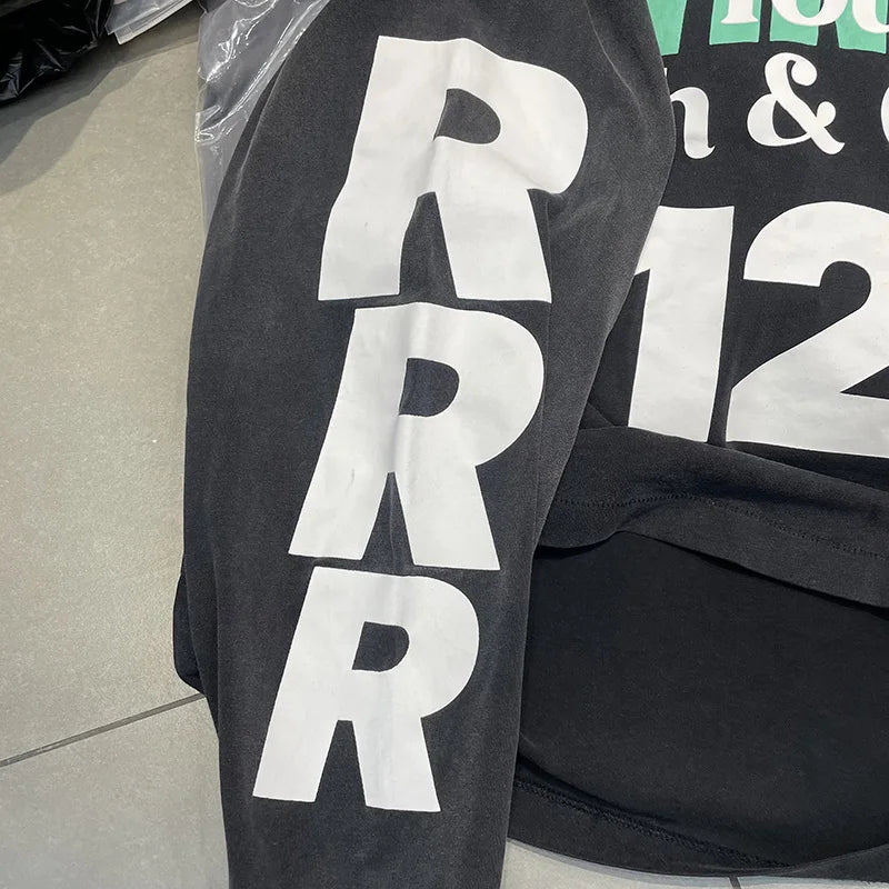 Black long-sleeved oversized cotton t shirt with bold white vertical hip hop letters logo graphics print