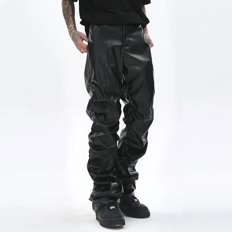 Black glossy faux leather hip hop mens pants with relaxed slouchy fit and visible stitching details