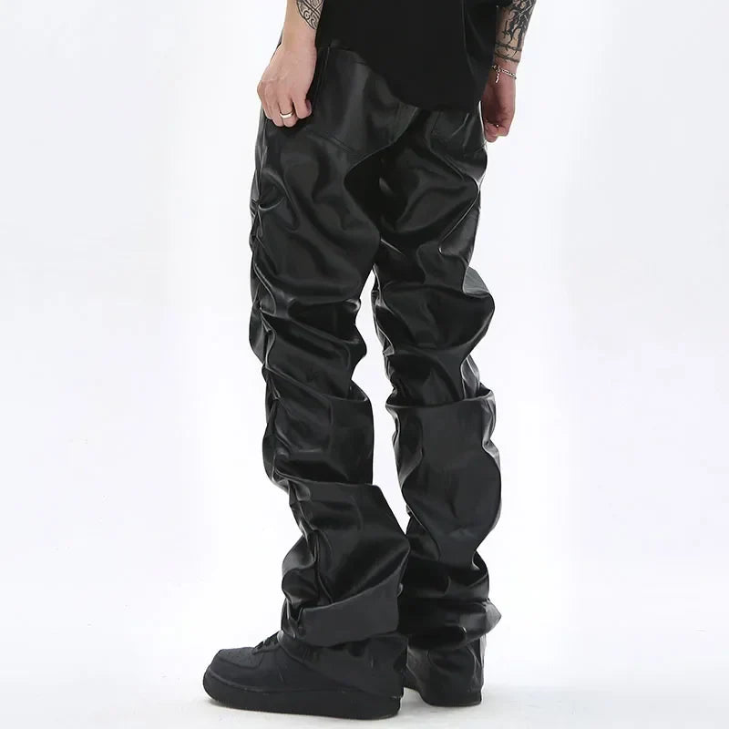 Black glossy faux leather hip hop mens pleated pants with relaxed slouchy fit and visible creases casual streetwear
