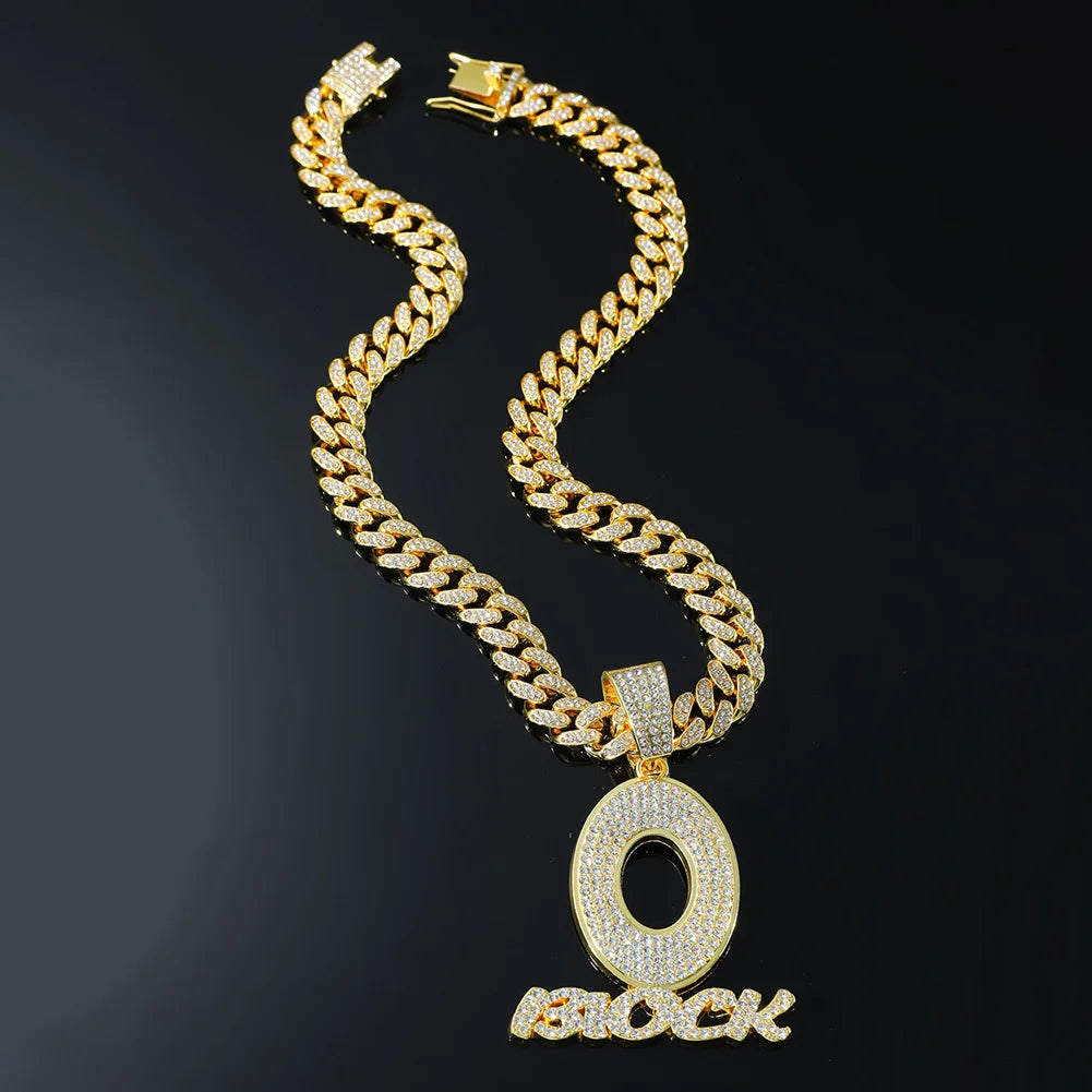Gold-colored cuban link chain necklace with diamond-encrusted o pendant and block text for men’s hip hop streetwear