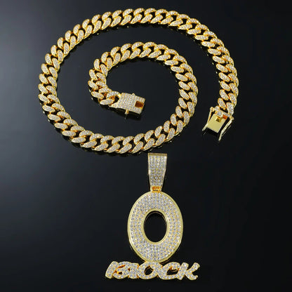 Gold-colored cuban link chain with diamond encrusted o pendant and block lettering hip hop men’s streetwear necklace