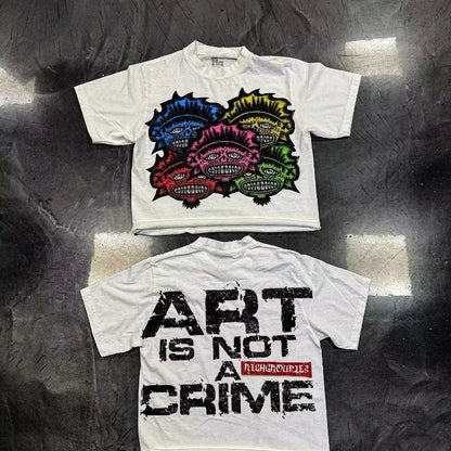 White cotton hip hop print t shirt with colorful spiky monsters on front and art is not a crime text on back