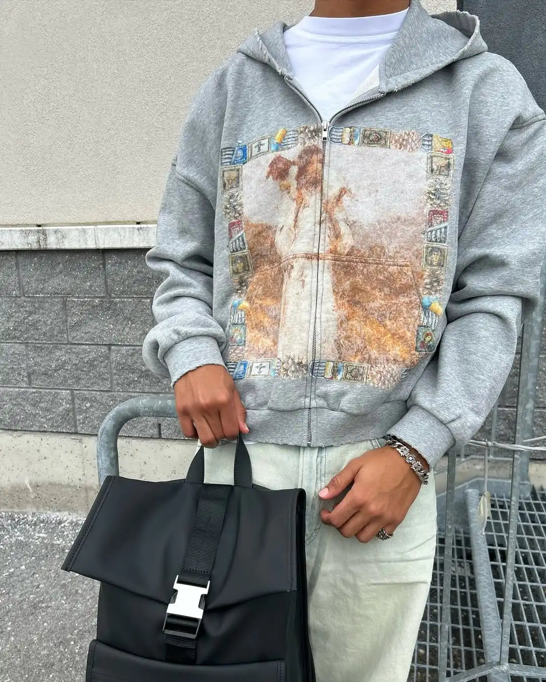 Black backpack with silver buckle and black webbing straps paired with retro spring casual hoodie personalized pattern printing harajuku