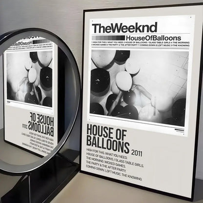 Black and white framed poster of the weeknd house of balloons album artwork with modern graphic beside circular mirror